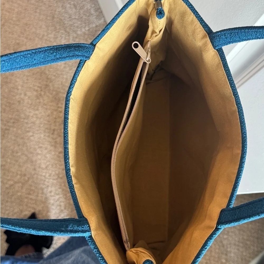 Teal-colored‎ handbag bag featuring intricate floral embroidery